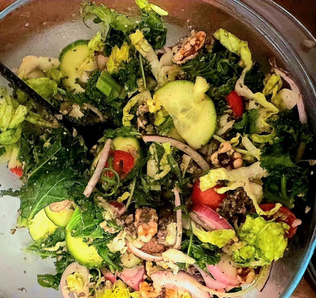 crumbled haggis on a backdrop of tomatoes, kale, rocket, lettuce, cucumber and a dressing drizzle