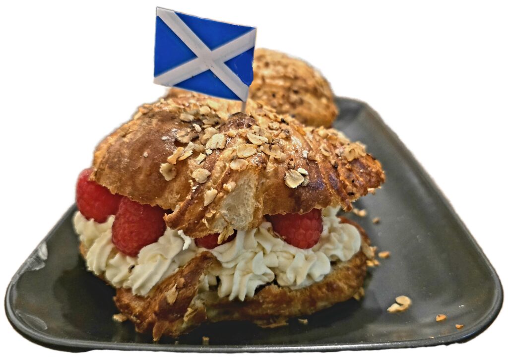 flaky golden croissant filled with whisky and honey cream. Topped with a scottish saltire flag on a cocktail stick.